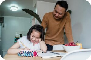 Parent supporting a child with ADHD to focus on learning tasks