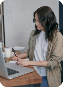 Adult professional reading on laptop at desk